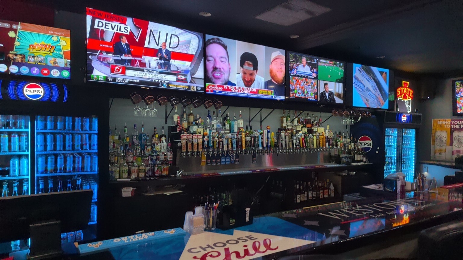 Westown Tap's full bar and wall of TVs